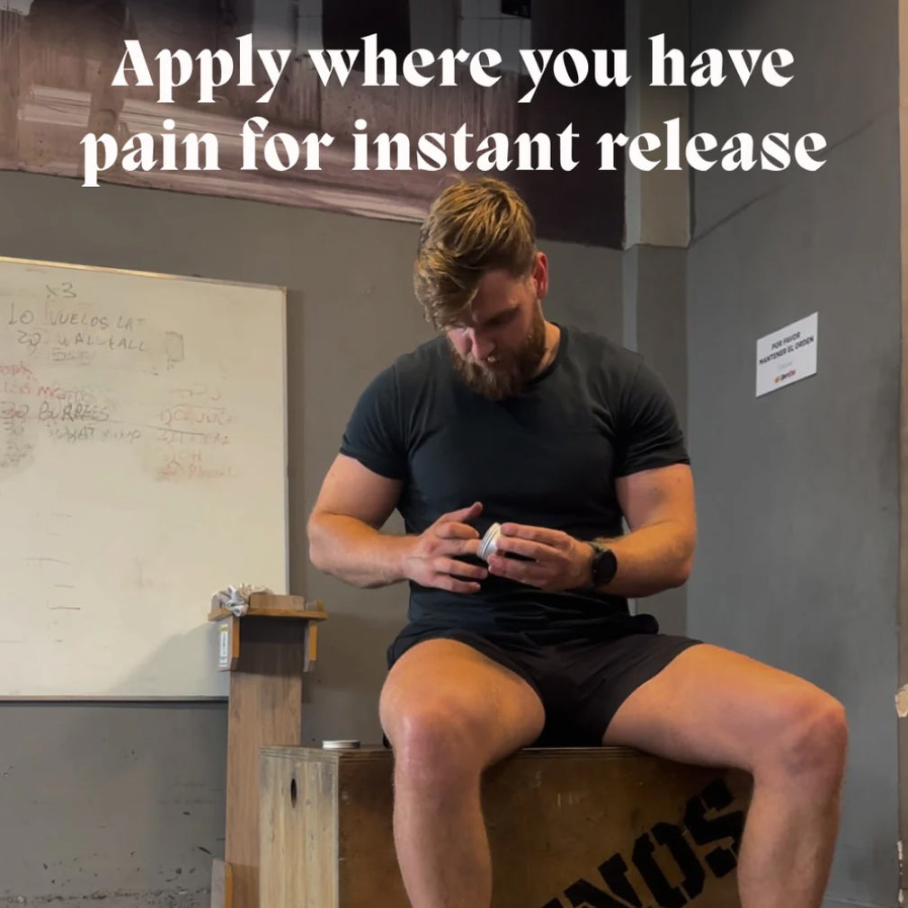 Hand holding the Muscle & Joint Builder Balm tin beside a gym use-case list for joint comfort