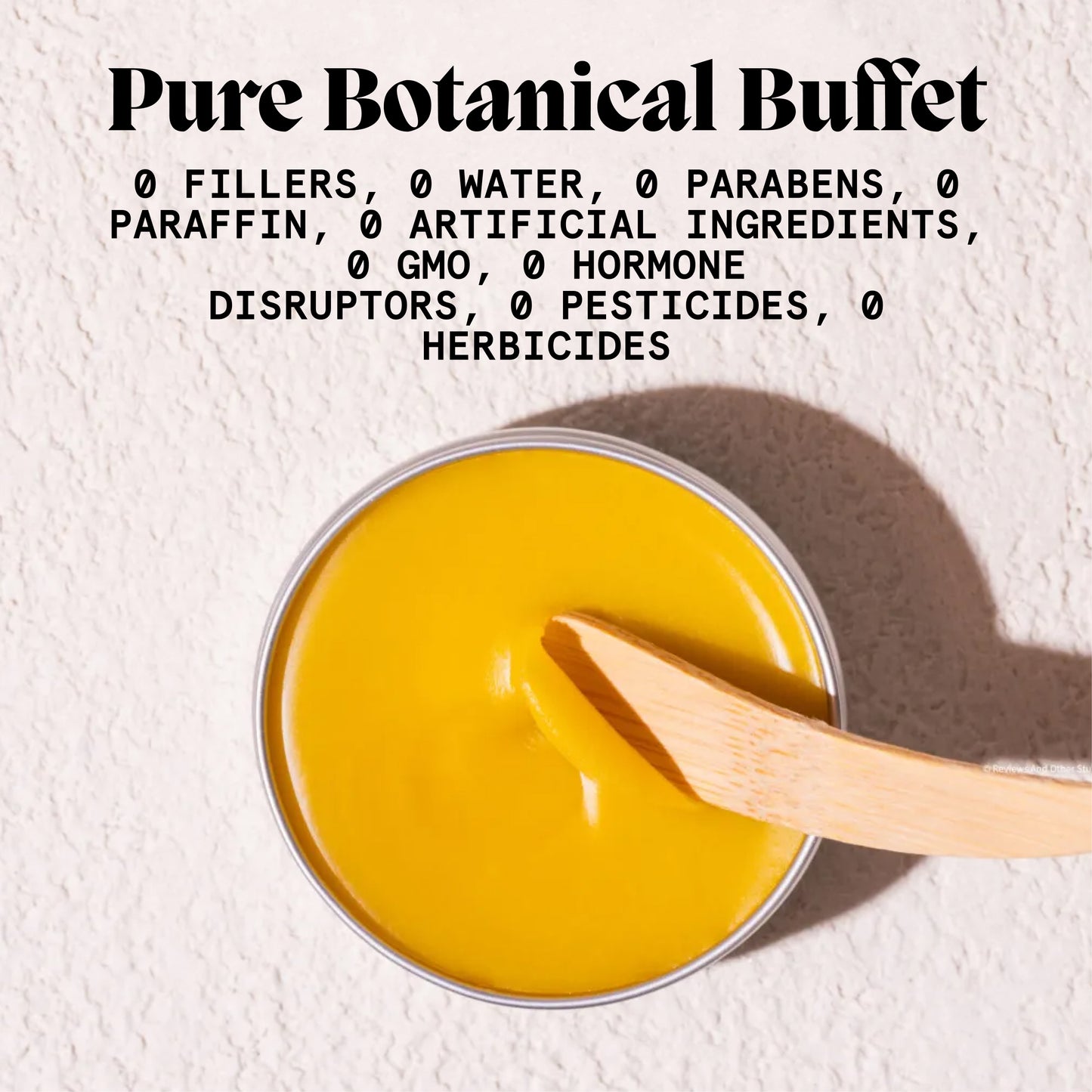 Open tin of body acne balm with bamboo spatula beside a free-from botanicals graphic