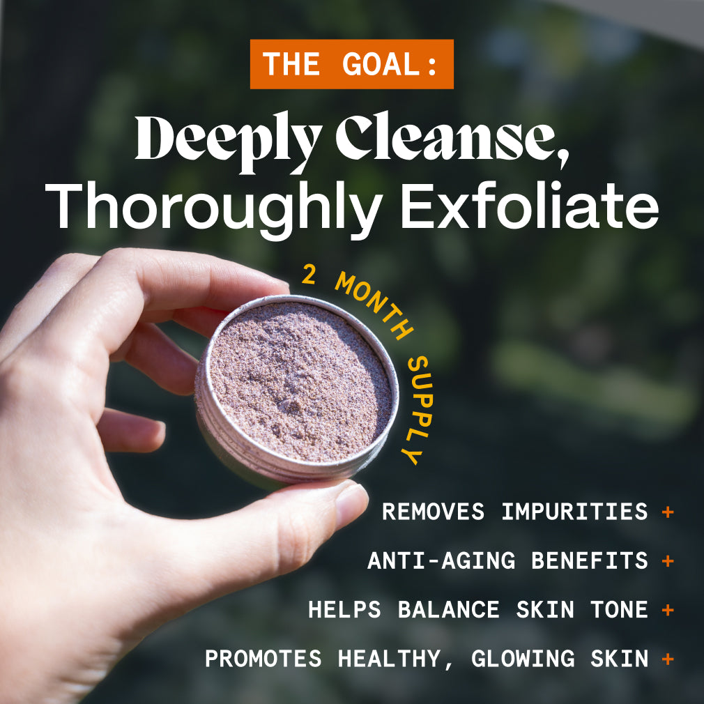 Hand holding open Scrub for Acne Prone Skin tin, graphic listing benefits of the exfoliating scrub